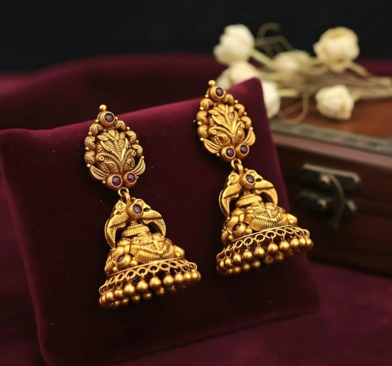 Antique gold peacock jhumka earrings set with ruby-red stones