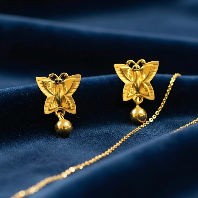 Gold butterfly stud earrings with bead drop