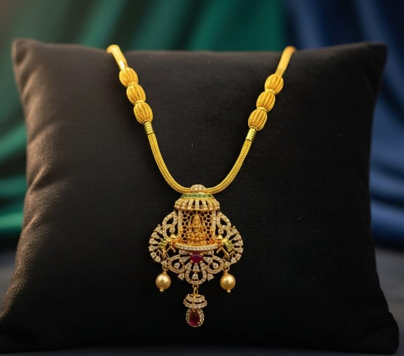 Gold chain with antique-finish Lakshmi pendant and ruby drop