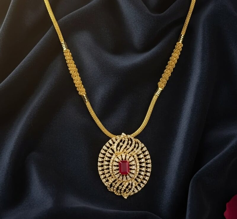 Gold chain with CZ-set oval pendant and ruby centre
