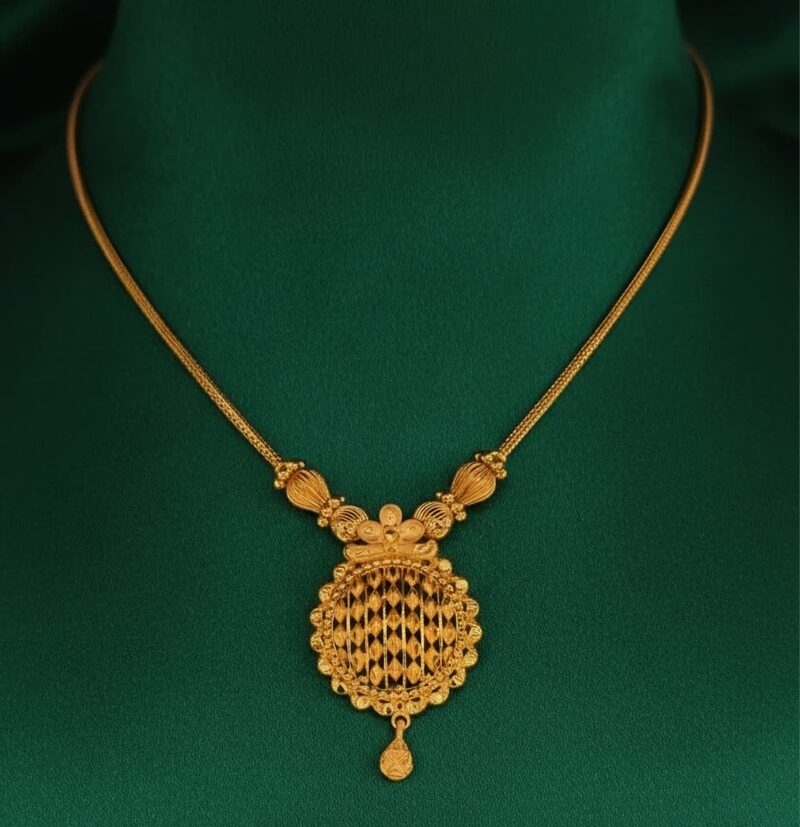 Slim gold chain necklace with round filigree pendant and drop