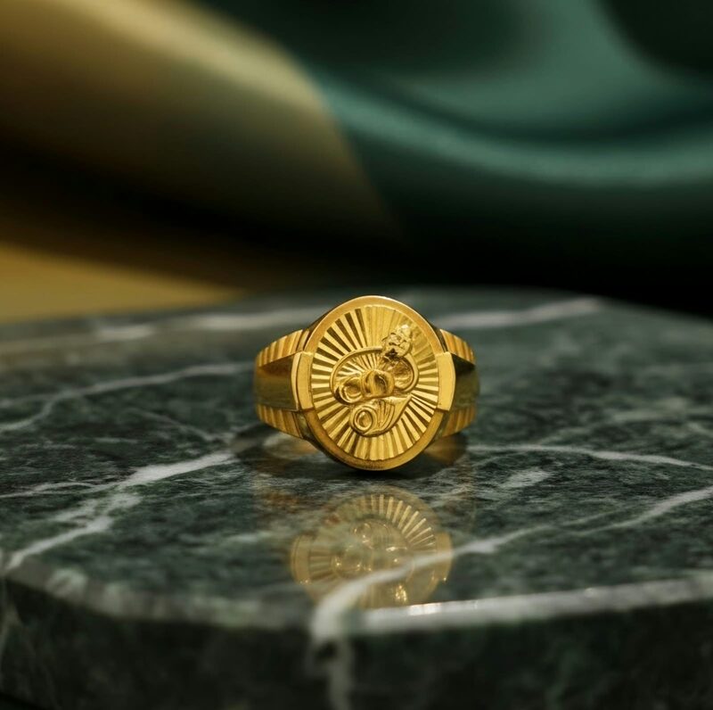 Gold ring with round embossed coin face