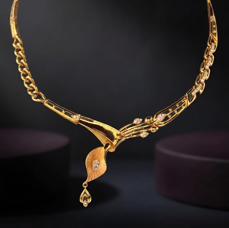 Contemporary gold necklace with curved leaf and CZ drop