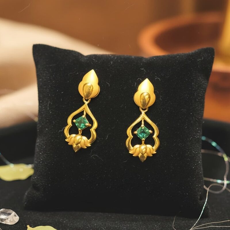 Gold drop earrings with green stone and lotus motif
