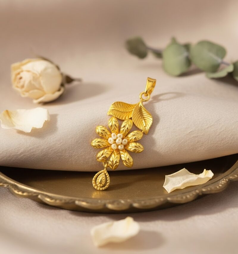 Gold flower pendant with pearl centres and leaf drop