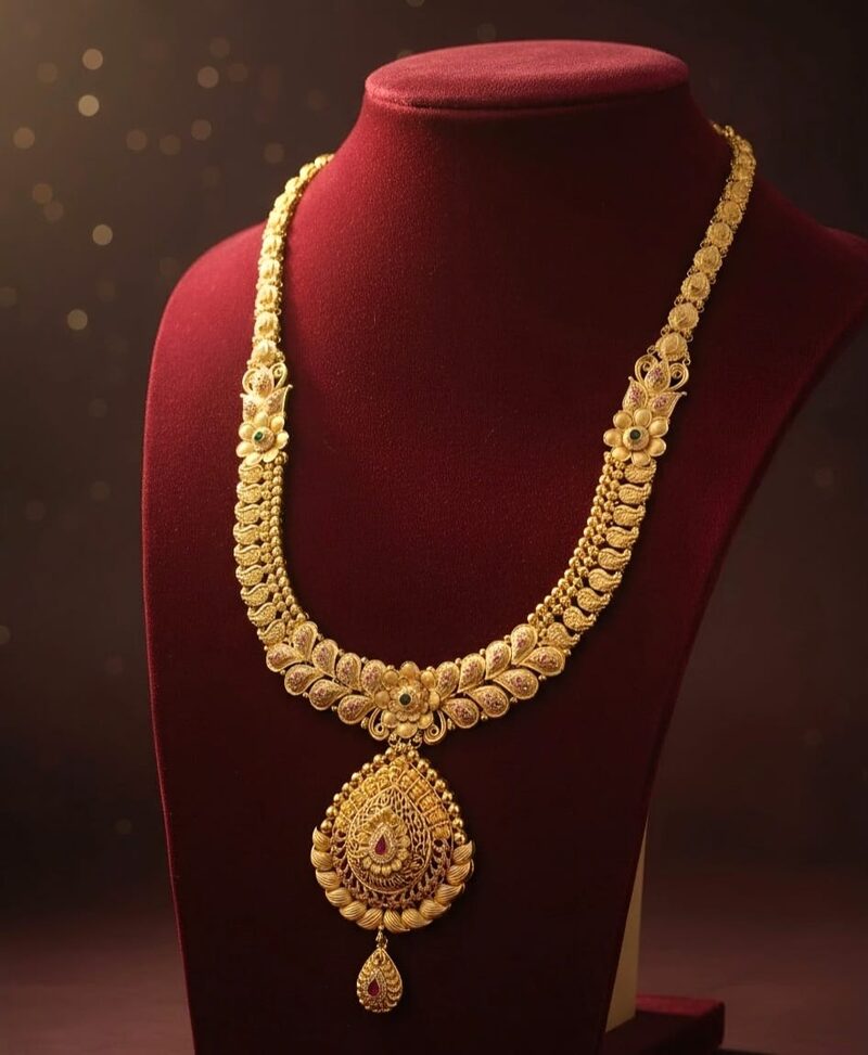 Gold necklace with leaf engraving and teardrop pendant