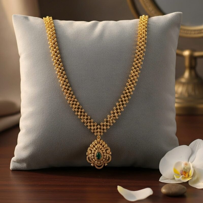 Long gold mesh chain with emerald-set pendant