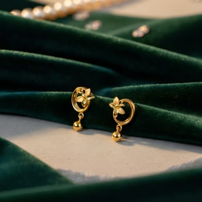 Small gold drop earrings with swirl motif and bead